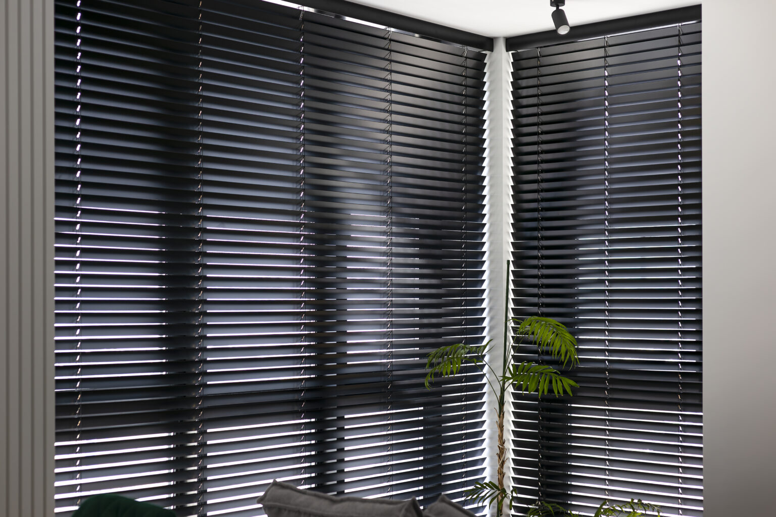 Automatic venetian blinds. Black color motorized wood blinds. Smart wooden shades on the window in the interior. Closed lamella shutters.